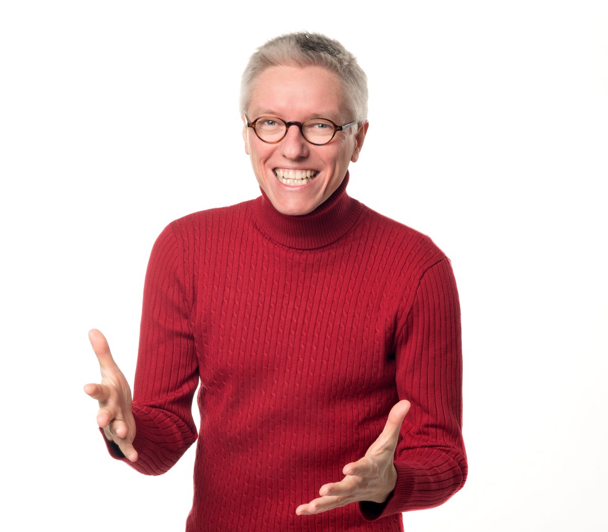 Dr. Bartholomäus Winkler im roten Rollkragenpullover, begeistert gestikulierend